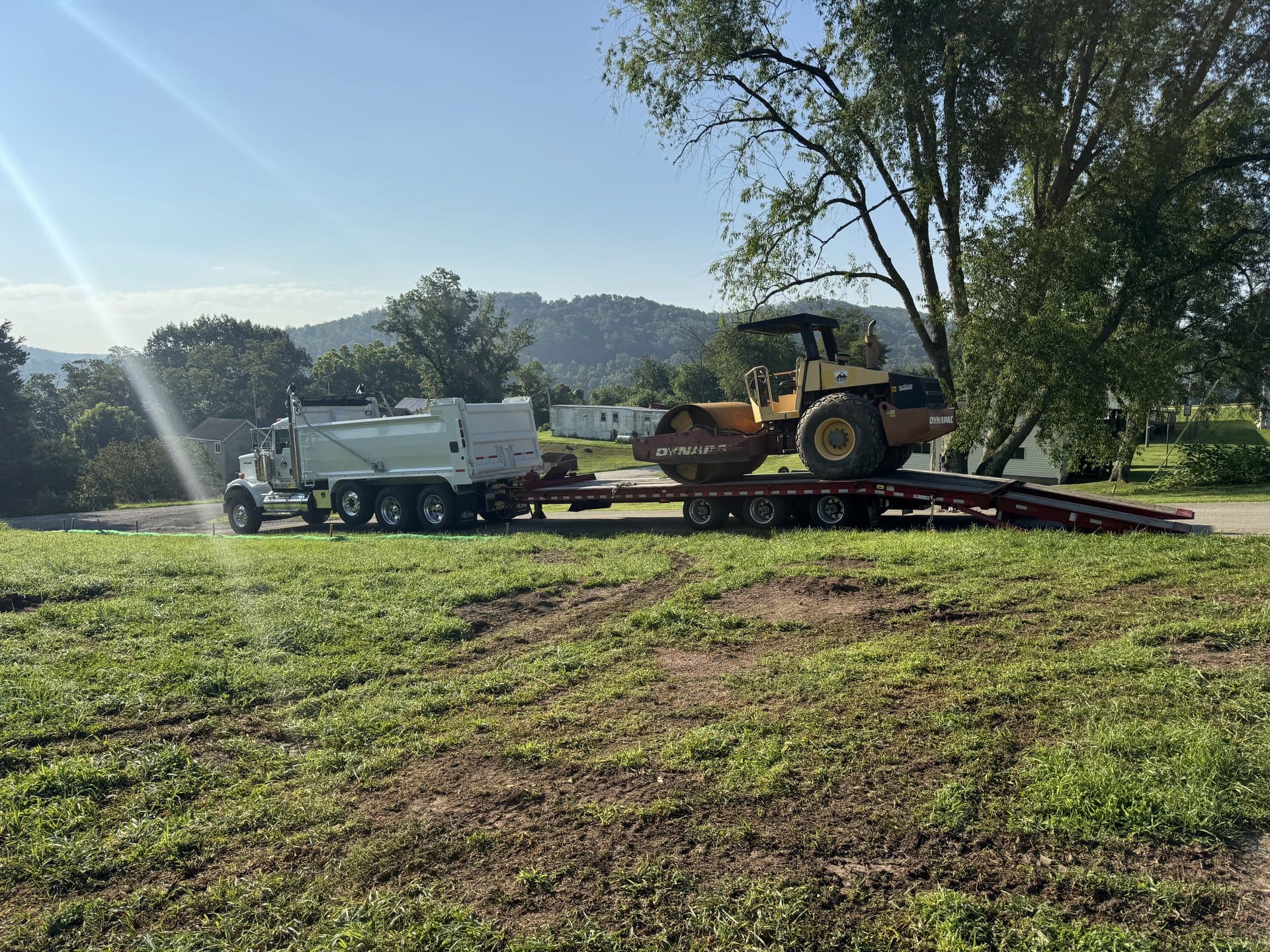 EW Wise dump truck delivering screened topsoil curbside