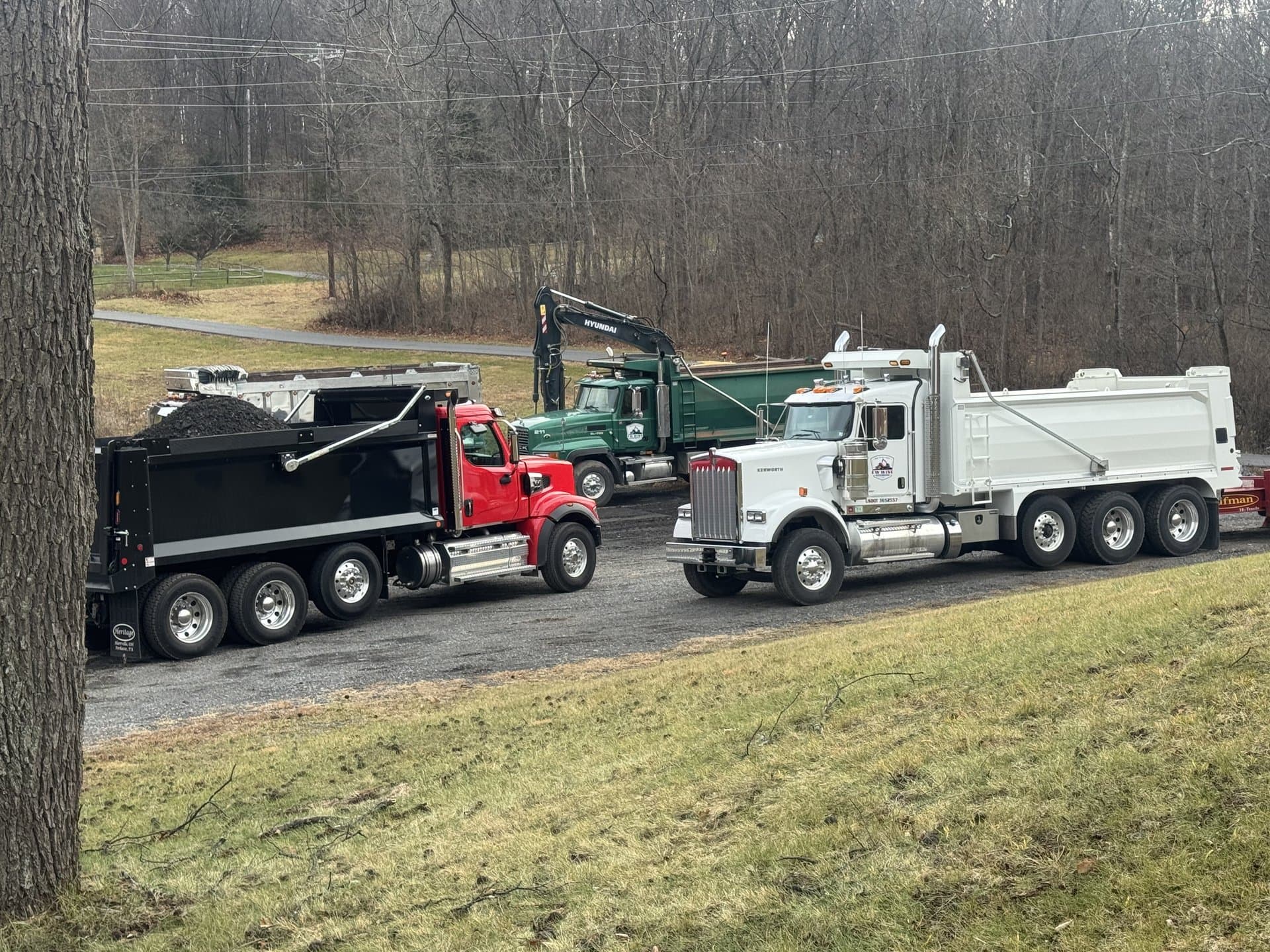 Two EW Wise dump trucks staged for the day's hauls